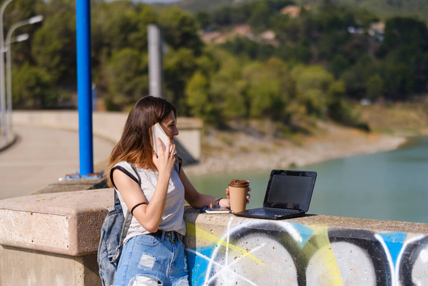 Girl working in the middle of nature with the laptop. - 写真・画像