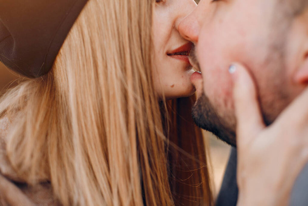Couple in a park. Blonde in a brown coat. Man with a beard - Fotoğraf, Görsel