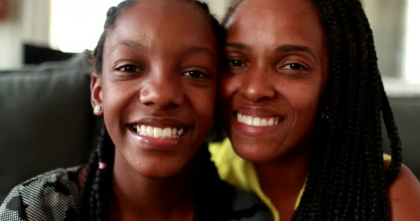 Mixed race mother and teenage girl daughter smiling at , Portrait African portrait faces - Filmati, video