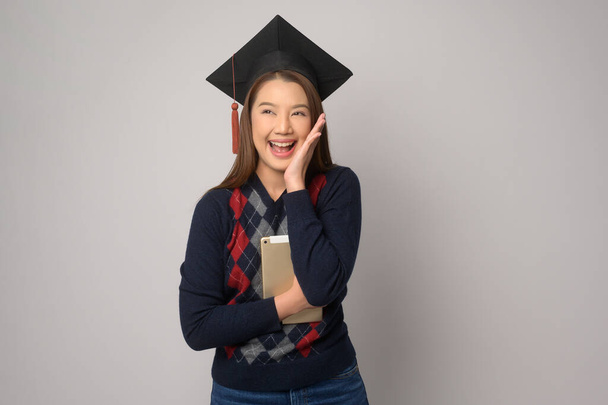 A Young smiling woman holding graduation hat, education and university concept	 - Foto, imagen
