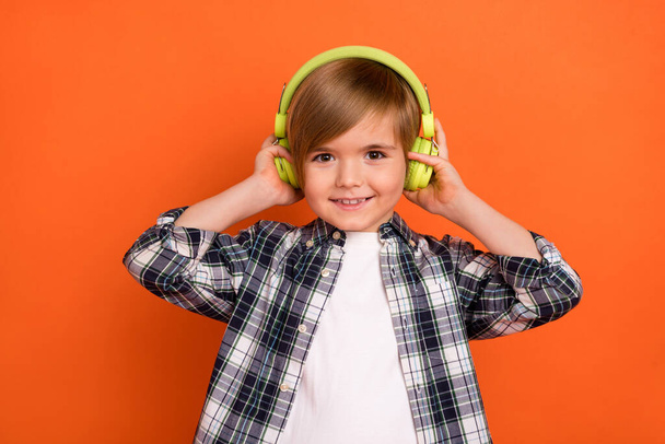 Photo of young little boy enjoy listen radio headphones meloman isolated over orange color background. - Φωτογραφία, εικόνα