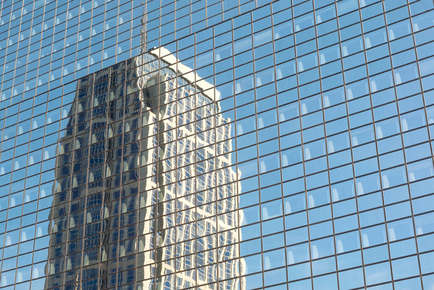 Shot of  distorted reflection of a building in the glazed facade of another building,  details.  - Fotó, kép