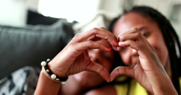 Madre e figlia che fanno simbolo del cuore con le mani. Etnia africana nera - Filmati, video