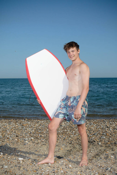 A 17 Year Old Teenage Boy With A body Board - Фото, изображение