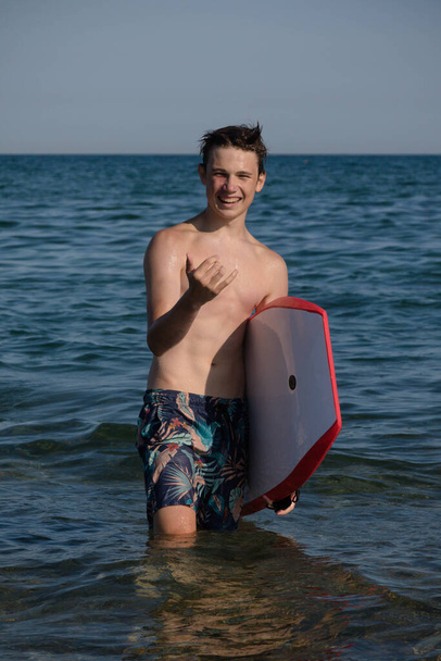 A 17 Year Old Teenage Boy In The Sea With A Body Board - Фото, зображення