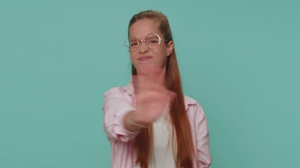 Dont want to hear and listen. Frustrated annoyed irritated pretty teenager girl covering ears, gesturing no, avoiding advice ignoring unpleasant noise loud voices. Young child kid on blue background - Imágenes, Vídeo