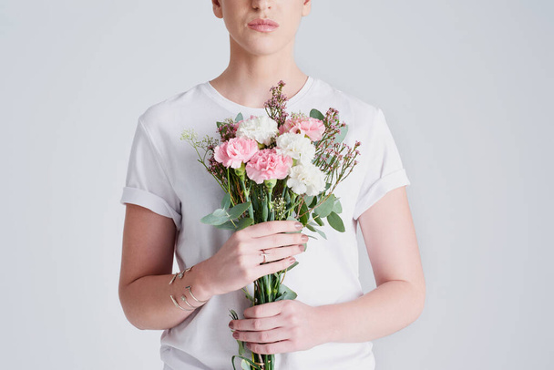 Live free like flowers in nature. Studio shot of an unrecognizable woman holding a bouquet of flowers against a grey background - Fotografie, Obrázek