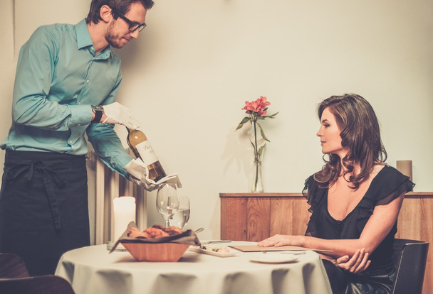 Waiter offering wine to lady - Photo, Image