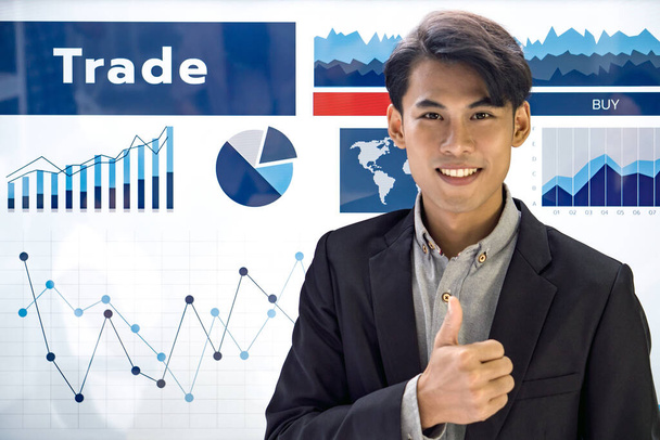 Young asian businessman in black suit raise finger thumb up in front of presentation monitor. - Foto, immagini