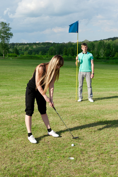 Golf woman player green putting hole golf ball - Foto, imagen