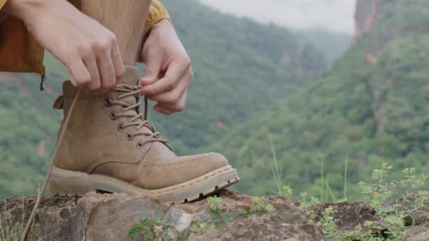 Hands of men tying shoe laces. Hiker getting ready for hiking. - Filmati, video