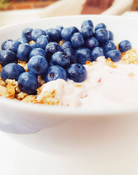 Blueberry yogurt cereal bowl as healthy breakfast and morning meal, sweet food and organic berry fruit, diet and nutrition concept - 写真・画像