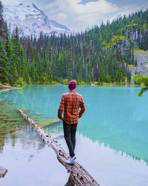 Озера Жоффре Британская Колумбия Whistler Канада, красочное озеро Жоффре озеро национального парка в Канаде. Молодые люди в шляпе посещают озеро Джоффре - Фото, изображение