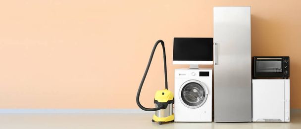 Different household appliances on beige background with space for text - Zdjęcie, obraz