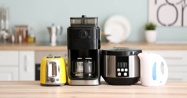 Different household appliances on kitchen table - 写真・画像