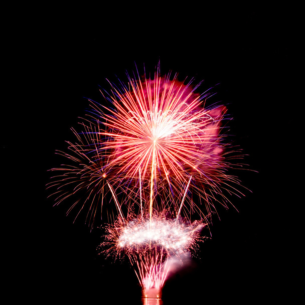 colorful fireworks over dark sky background - Foto, afbeelding