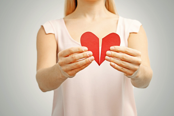broken red heart in woman hands. concept of relationship, divorc - Photo, Image
