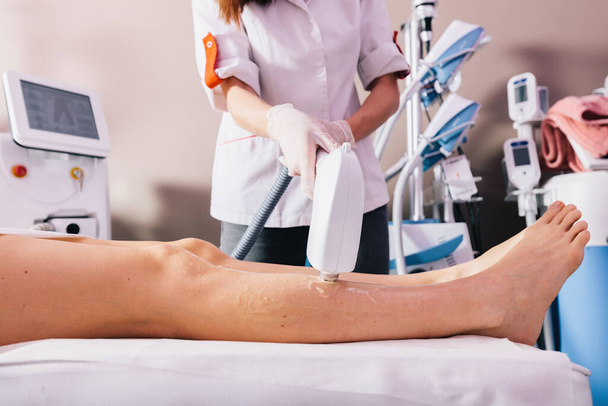Woman on laser hair removal treatment on leg. Skin and body care - Foto, imagen