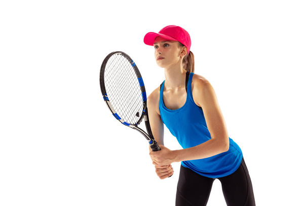 Receiving a serve in tennis. Professional tennis player training isolated on white background. Skills, studying, sport, challenges concept. Athlete looks concentrated - Foto, Imagen