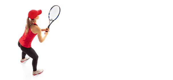 Receiving a serve in tennis. Professional tennis player training isolated on white background. Skills, studying, sport, challenges concept. Athlete looks concentrated. Flyer - Фото, зображення