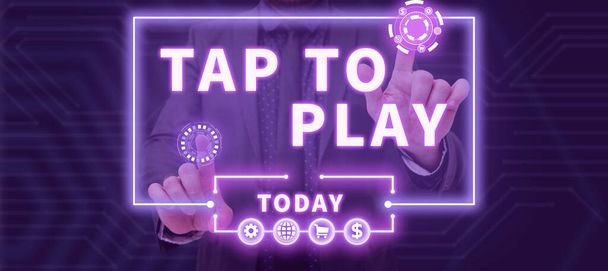 Text sign showing Tap To Play, Business approach Touch the screen to start playing a game or something else Businessman Pointing With Two Fingers On S And Presenting New Ideas. - Foto, imagen