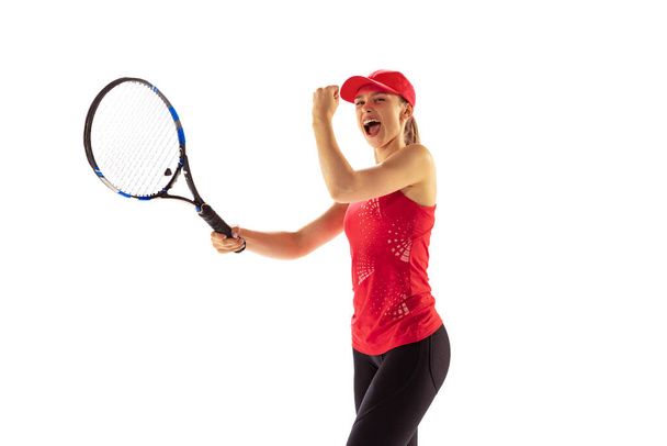 Victory. Excited young woman, tennis player shouting after sports win isolated on white background. Healthy lifestyle, fitness, sport, exercise concept. Emotions, facial expressions, achievement - Fotografie, Obrázek