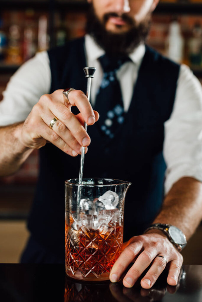 close up of barman stirring ice in glass - 写真・画像