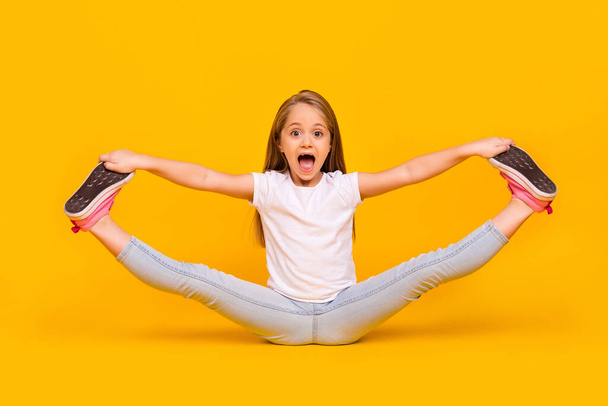 Full length photo of funky pretty schoolgirl dressed white t-shirt sitting floor split legs isolated yellow color background. - Foto, Bild