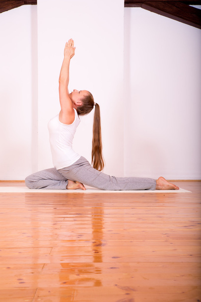 Woman practicing Yoga in a Studio	 - Фото, изображение