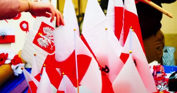 National Independence Day of Poland. Flag of Poland. The seller puts up for sale Polish flags with the coat of arms, wreaths, key chains and other souvenirs. Celebration in the Warsaw - Video
