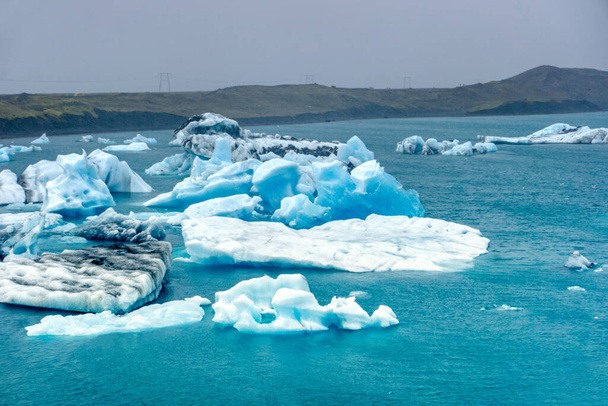 Ice floes at Jokulsarlon glacial lagoon in Iceland - most famoust tourist attraction - Foto, Bild