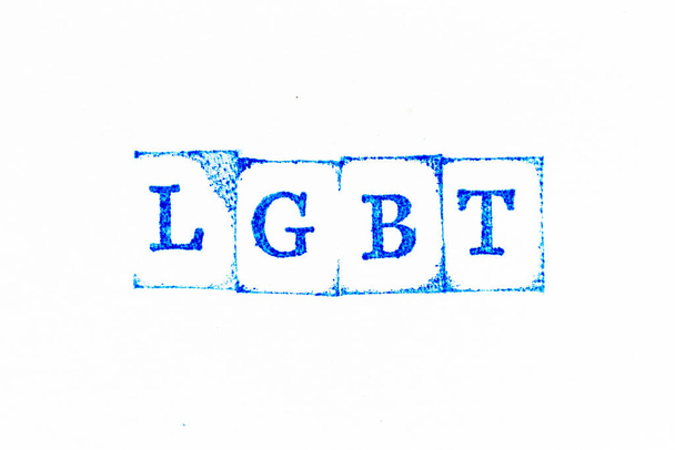 Blue color ink rubber stamp in word LGBT (Abbreviation of lesbian, gay, bisexual, and transgender) on white paper background - Zdjęcie, obraz
