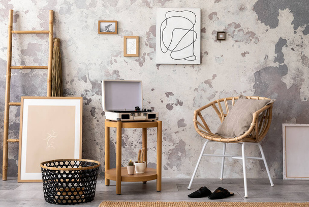 The stylish composition of living room interior with mock up, chair, wooden coffee table with gramophone and personal accessories. Mock up poster. Home decor. Template.  - 写真・画像