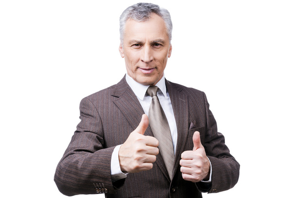 Mature man in formalwear showing  thumbs up - Foto, afbeelding