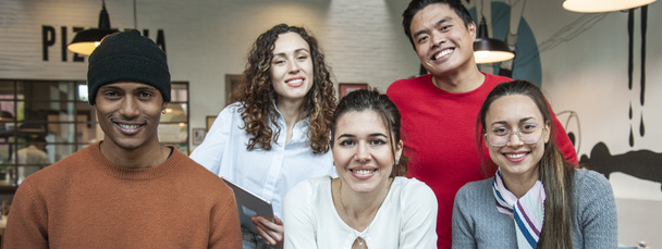 Horizontal banner or header with smiling multiethnic coworkers looking at camera making team picture in multifunctional room of the pizza restaurant for working brunch - Diverse work group - 写真・画像