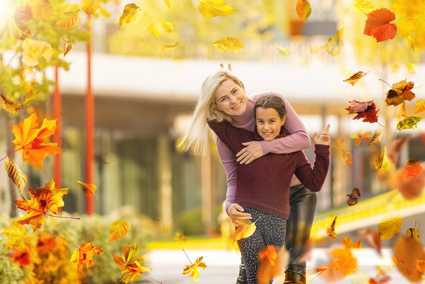 Happy family on autumn walk Mother and daughter walking in the Park and enjoying the beautiful autumn nature. High quality photo - Fotografie, Obrázek
