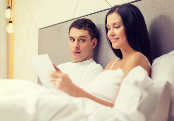 smiling couple in bed with tablet pc computers - Photo, Image