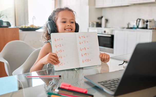 Zoom class, virtual teaching lesson and online education with clever kid showing math homework, test and sums for distance learning on video call with laptop. Home school child, girl and student. - Foto, Imagem