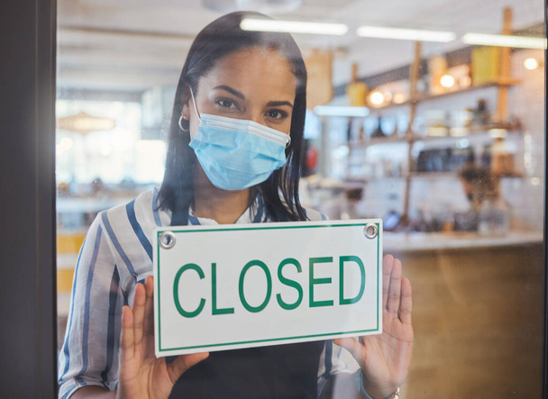 Compliance, safety and economic crisis closing store due to covid19 pandemic, sad and in debt. Small business owner frustrated about fail startup, hanging a sign on the window or entrance of shop. - Foto, imagen