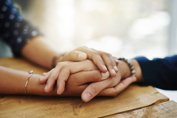 Be the person who helps the next. Closeup shot of two unrecognizable people holding hands in comfort - Foto, afbeelding