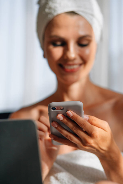 Woman looking on mobile screen and gesturing for expressing happiness. Good news, emotions and technology concept. Woman looking on mobile screen. Winning in the mobile application, jackpot. - Photo, image