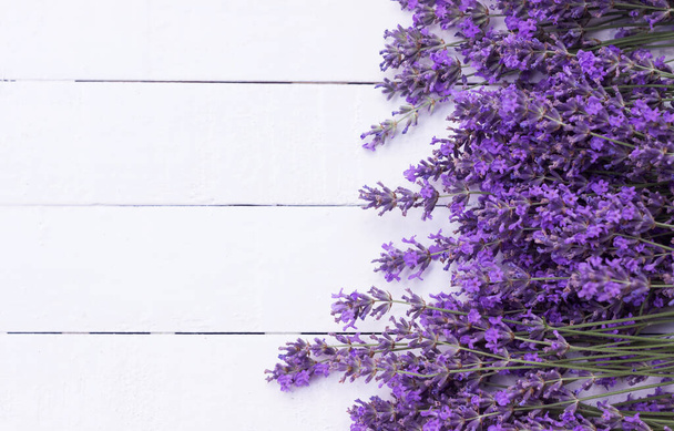 Fragrant lavender flowers on a white wooden background. Place for text - Foto, Imagem