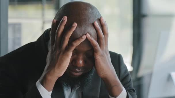 Sick exhausted african man suffer from headache migraine syndrome hold head by hands tired overworked american adult disappointed unhealthy businessman feel discomfort tension pressure mental fatigue - Imágenes, Vídeo