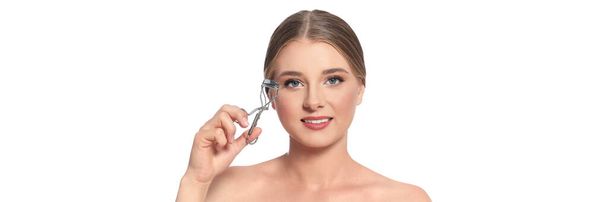 Young woman with eyelash curler on white background. Banner design - Zdjęcie, obraz