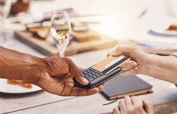 Restaurant customer payment with credit card on machine or digital tech for contactless and secure payment while fine dining. Food business manager or waiter hands using 5g to tap or scan a bank card. - Foto, Bild