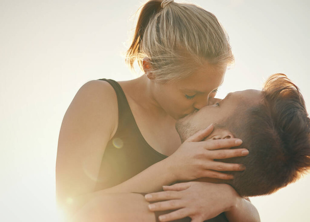 Kissing is a great calorie burner. a young couple kissing outdoors - Foto, Imagem