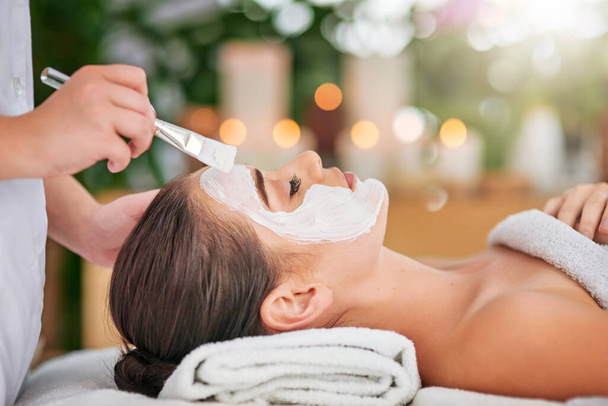 Give your skin the special treatment it deserves. an attractive young woman getting a facial treatment at a spa - Photo, image
