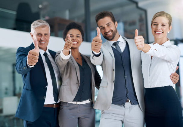 Занятые рабочие дни. мотивированный бизнес-команда показывая большие пальцы вверх и улыбаясь - Фото, изображение