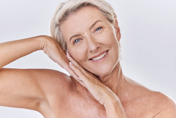 Skincare, clean and happy senior woman face resting on hands in a studio portrait. Elderly beauty skin care model posing or showing bedtime routine for perfect, healthy looking or wrinkle free aging. - Foto, imagen