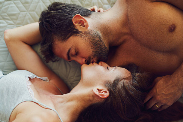 Youre just too good to be true. High angle shot of an affectionate couple lying in bed together - Zdjęcie, obraz